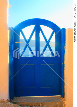 blue house door and sea on Santorini, Greece 21700536