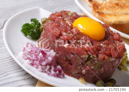 tartare meat with egg, onion and capers closeup 21705190