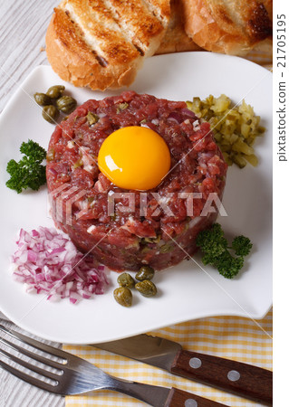 Beef tartare close up on a white plate. top view Beef tartare close up on a white plate. top view 21705195