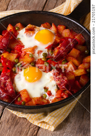 Fried eggs with chorizo and vegetables in the pan Fried eggs with chorizo and vegetables in the pan 21705197