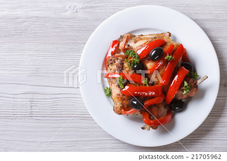 Roasted rabbit leg with pepper and olives top view Roasted rabbit leg with pepper and olives top view 21705962