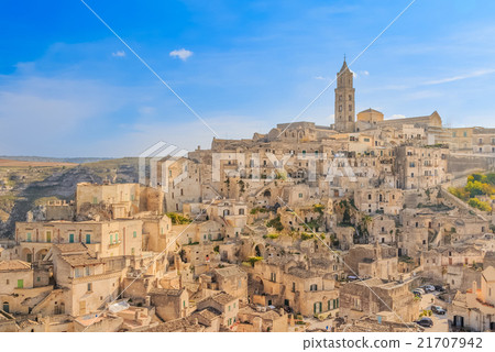 panoramic view of typical stones (Sassi di Matera) and church of Matera UNESCO European Capital of Culture 2019 under blue sky 21707942