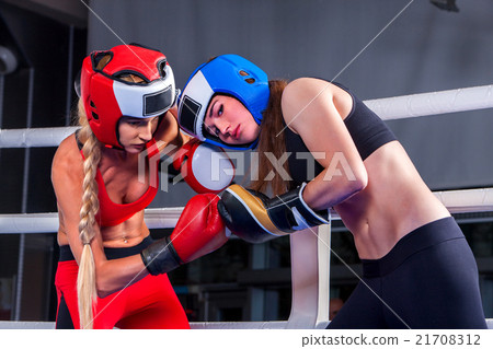 Stock Photo: Two women boxing in the ring.