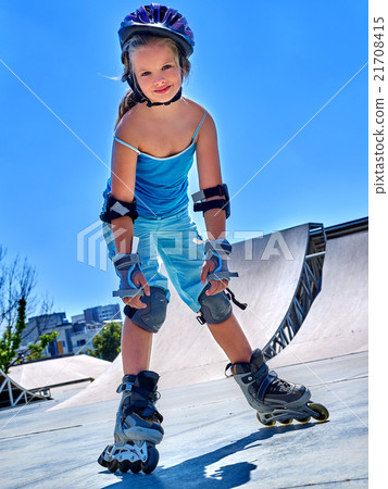 Girl rides on roller skates in skatepark. Girl rides on roller skates in skatepark. 21708415