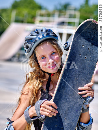 Girl holding a skateboard in hands. Girl holding a skateboard in hands. 21708416
