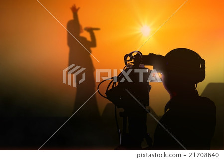 Cameraman shooting a live concert on stage 21708640