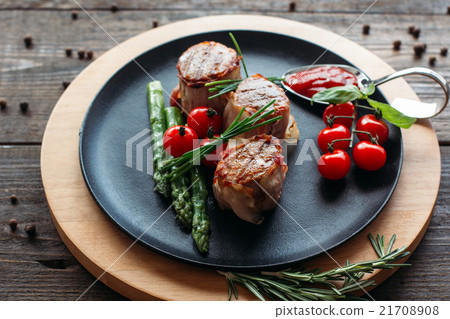 Grilled pork with vegetables on black plate Grilled pork with vegetables on black plate 21708908