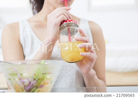 A woman drinking juice 21709565