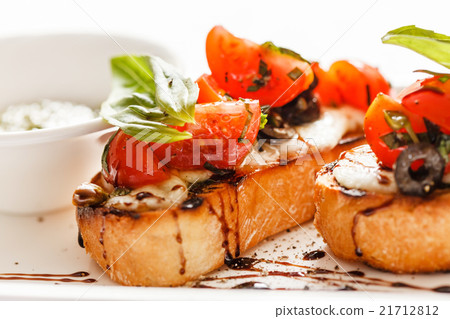 Bruschetta with tomato, mozarella and basil Bruschetta with tomato, mozarella and basil 21712812