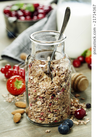 Close up of jar with granola or muesli on table 21714367