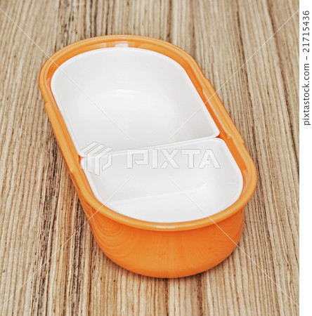 Orange folding plastic food box on the wooden background, kitche 21715436