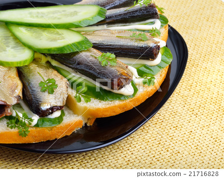 Appetizer with sprats and green cucumber Appetizer with sprats and green cucumber 21716828