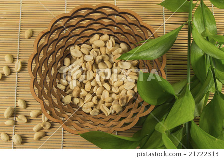 Salted peanuts in a wooden bowl on a bamboo Mat Salted peanuts in a wooden bowl on a bamboo Mat 21722313