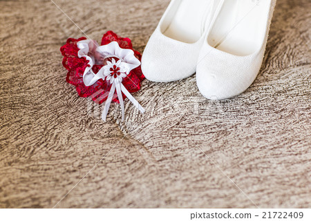 Bride's shoes and red wedding garter 21722409