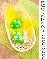 Easter eggs in a basket  with yellow feathers 21724668
