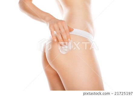 Woman applying moisturizer cream on legs isolated 21725197