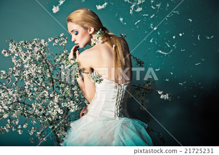 Bride in wedding dress behind bush with flowers Bride in wedding dress behind bush with flowers 21725231