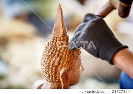 Hand of carver carving wood 21727894