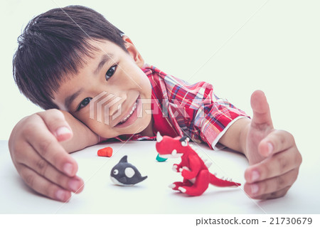 Child show his works from clay, on white. 21730679