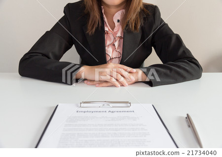 Businesswoman sitting with employment agreement Businesswoman sitting with employment agreement 21734040