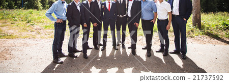 bride and groom standing with guests in garden 21737592
