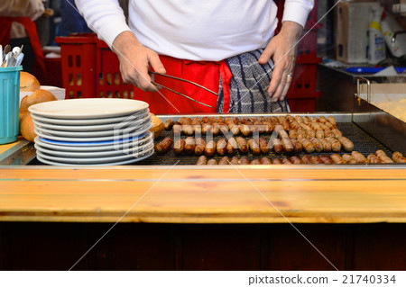 man grill hot dogs in the shop in Germany man grill hot dogs in the shop in Germany 21740334