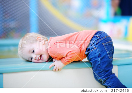 Active toddler boy playing at indoors playground Active toddler boy playing at indoors playground 21742456