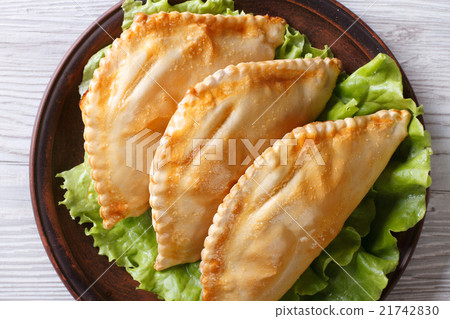 empanadas on a plate close-up view from above 21742830