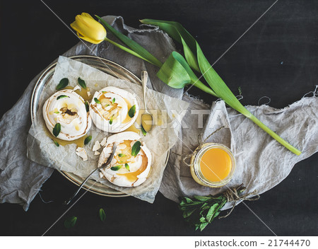 Merengues with lemon curd, fresh mint on silver 21744470