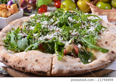 Freshly cooked pizza topped with cheese and sesame Freshly cooked pizza topped with cheese and sesame 21748909