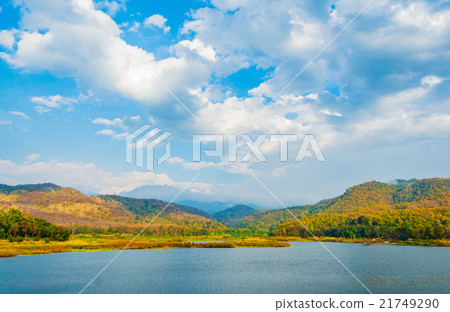 lake with blue sky and mountain in background 21749290