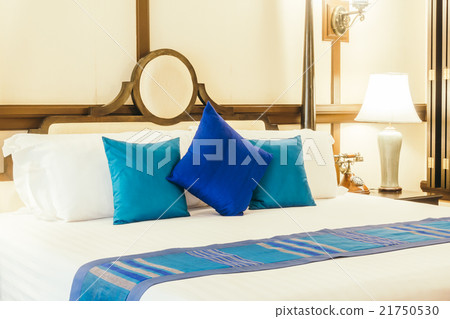 Pillow on bed with light lamp 21750530