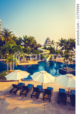 Beautiful Silhouette palm tree with umbrella and chair Beautiful Silhouette palm tree with umbrella and chair 21750994