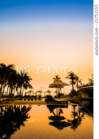 Beautiful Silhouette palm tree with umbrella and chair 21751555