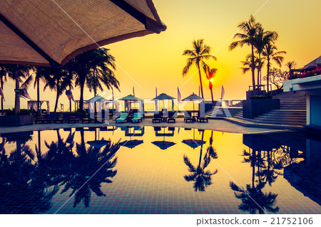 Beautiful Silhouette palm tree with umbrella and chair Beautiful Silhouette palm tree with umbrella and chair 21752106