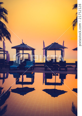 Beautiful Silhouette palm tree with umbrella and chair Beautiful Silhouette palm tree with umbrella and chair 21752128