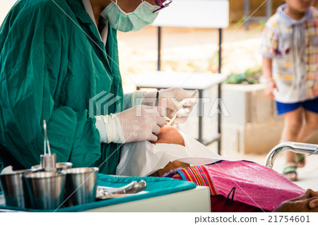 Dentist examining a patient's teeth in the dentist 21754601