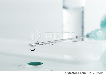 Medical syringe with injection solution drop. Medical syringe with injection solution drop. 21758504