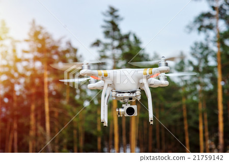drone flying on a background of forest trees 21759142