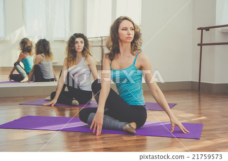 Two slim women are doing yoga in studio Two slim women are doing yoga in studio 21759573