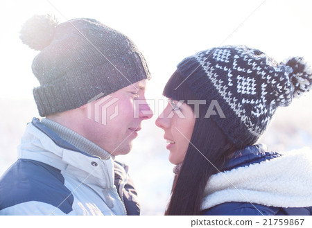 Young couple looking each other in winter Young couple looking each other in winter 21759867