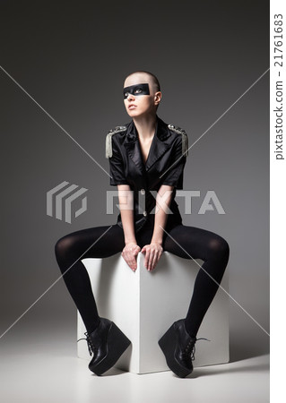 agressive bald sitting woman with mask makeup 21761683