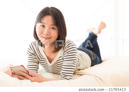 Woman using a smartphone Woman using a smartphone 21765413