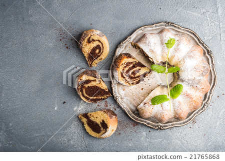 Zebra bundt cake cut into pieces and mint leaves Zebra bundt cake cut into pieces and mint leaves 21765868
