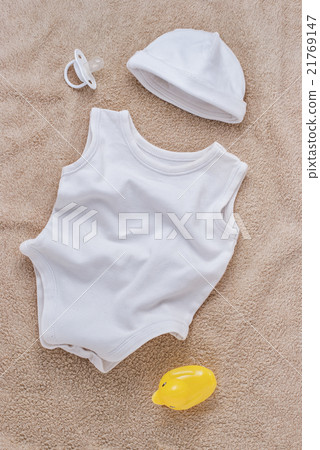 Baby clothes and pacifier on soft towel 21769147