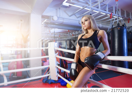 Young pretty boxer woman standing on ring 21772520