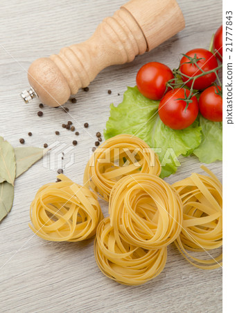 Pasta, tomatoes and pepper on a wooden background 21777843
