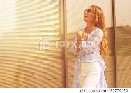 Businesswoman smiling near office building Businesswoman smiling near office building 21779480