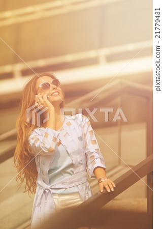 Businesswoman talking over mobile phone Businesswoman talking over mobile phone 21779481