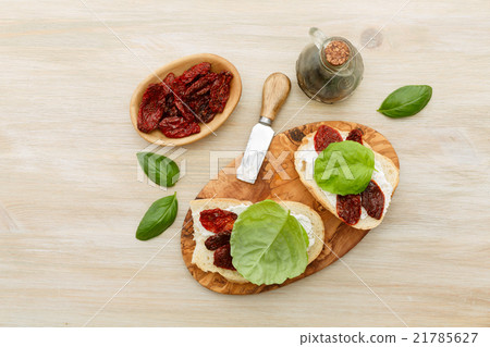 Sandwiches with mascarpone, dried tomatoes, basil 21785627
